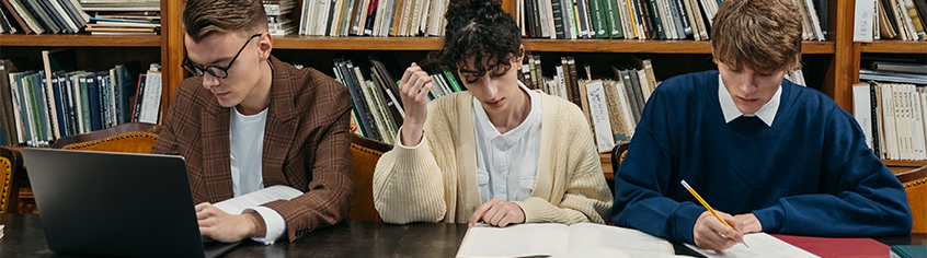 Three students in a library